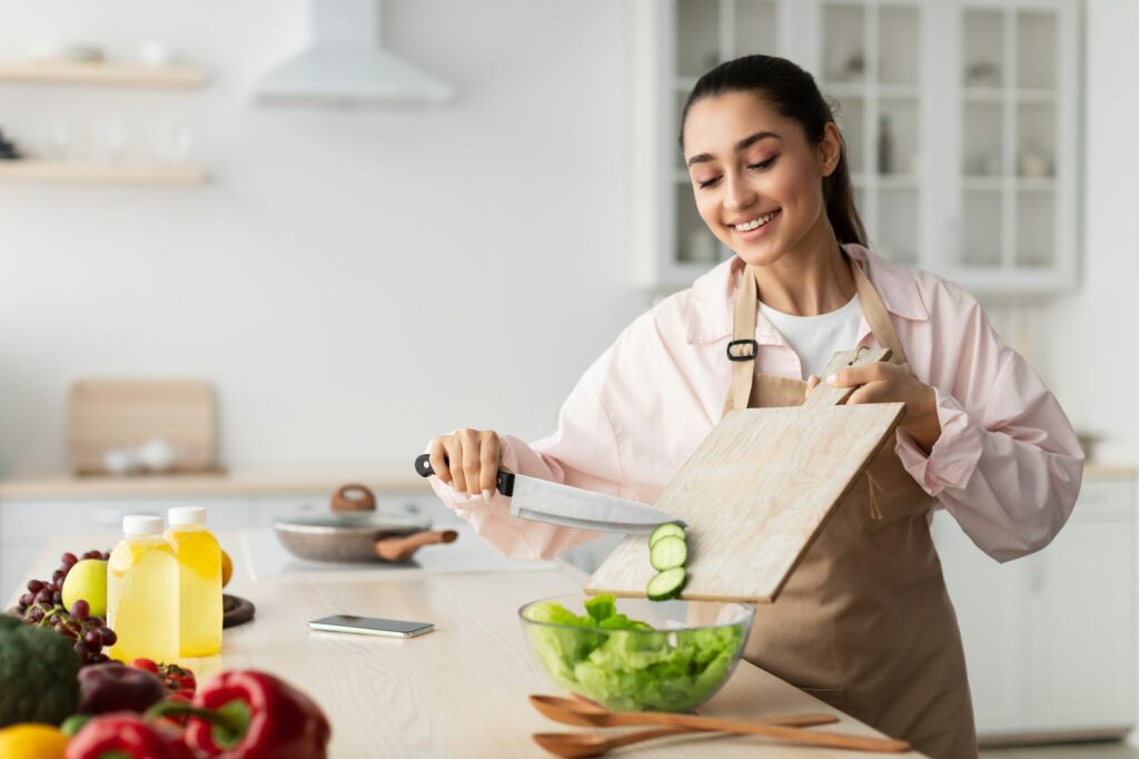 Healthy Food To Boost Your Immune System. Woman cooking salad