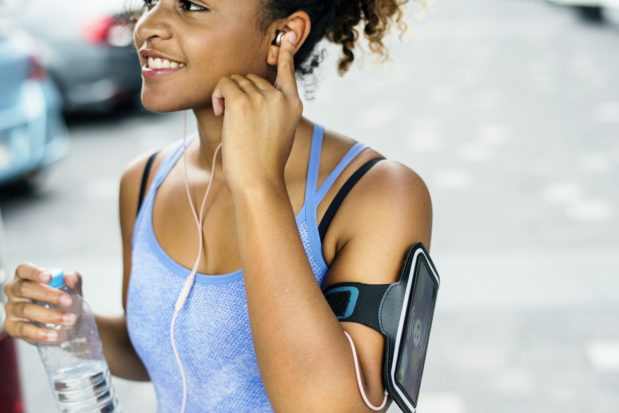 Healthy woman exercising while using technology