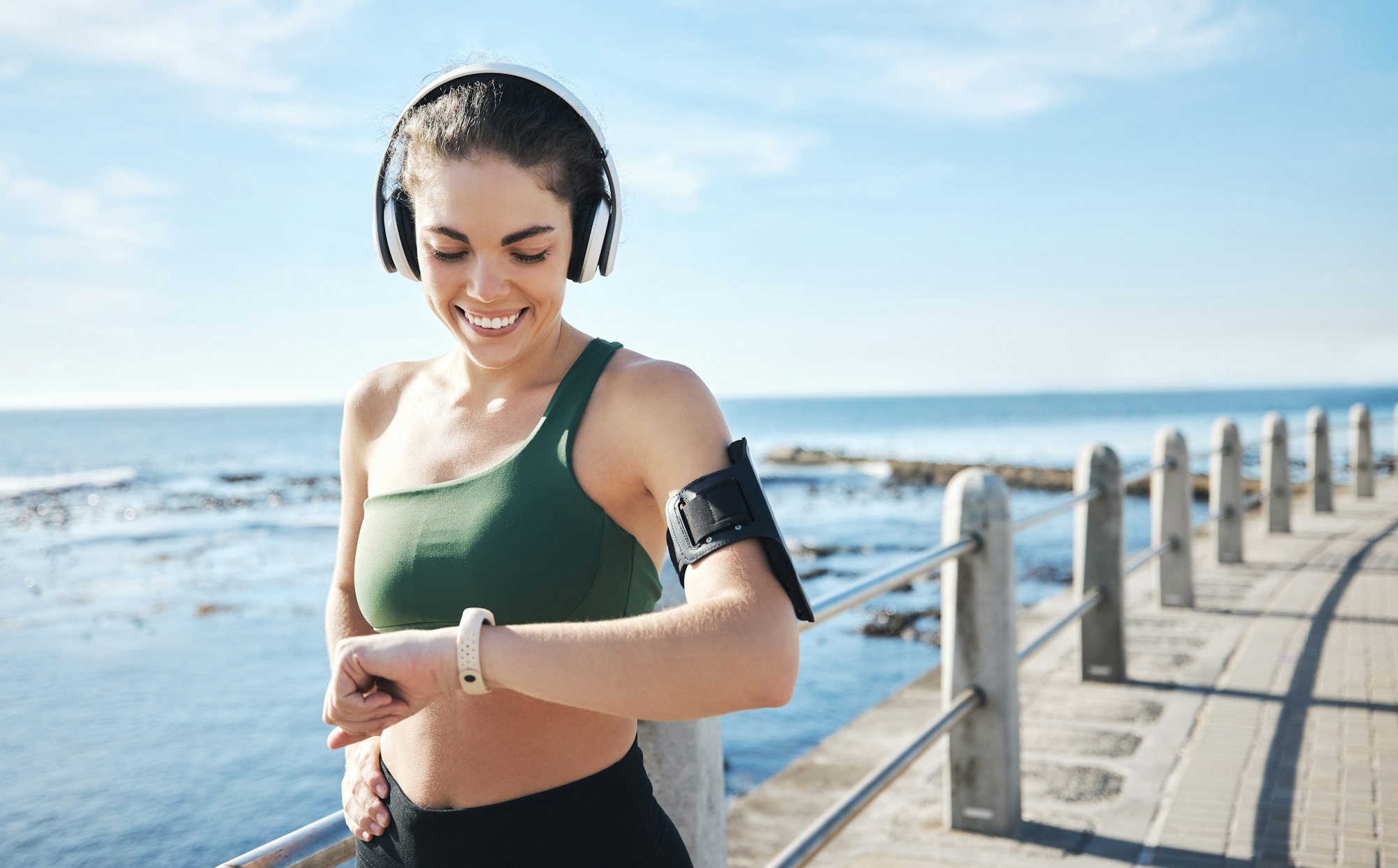 Headphones, smartwatch and woman running for workout, exercise and health results, progress or fitn