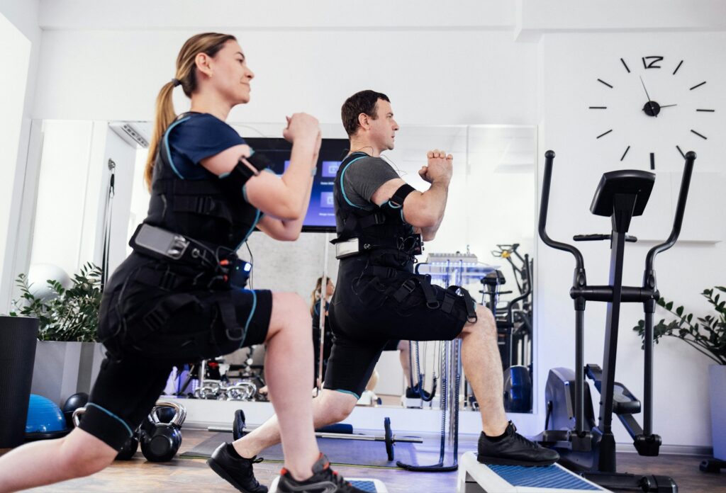 Sport couple in ems suits is engaged in physical activity in fitness club or gym